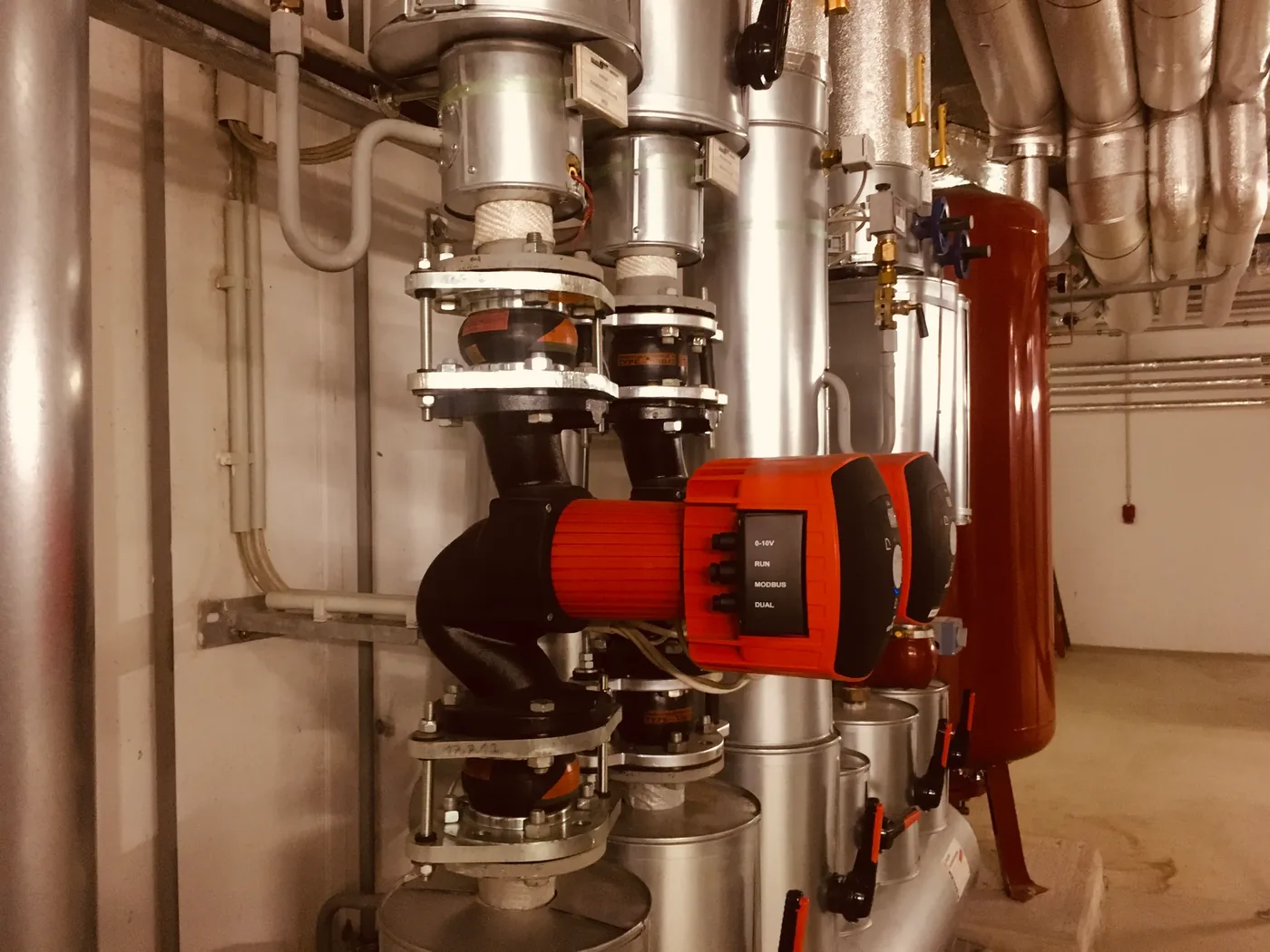 Technikraum mit Rohrleitungen und Pumpen einer Wärmeversorgung